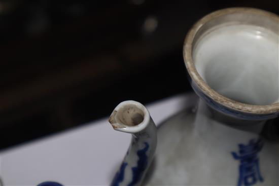 A Chinese Kangxi period blue and white wine pot and a Qianlong period helmet shaped milk jug Height of pot 16cm